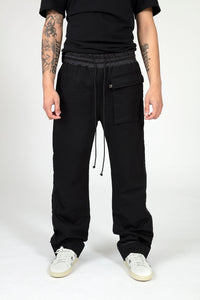 Mens black drawstring baggy casual luxury fashion mens trousers close up view front with white sneakers